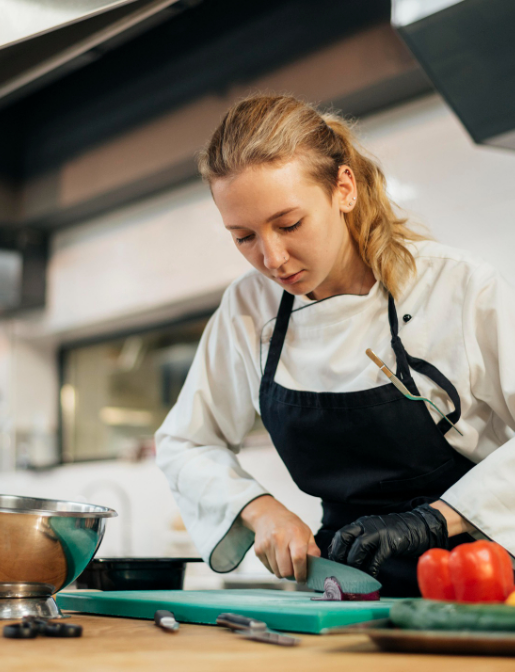 female-chef-chopping-vegetables-kitchen